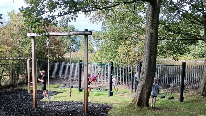 Children using outdoor activity equipment during a residential adventure weekend